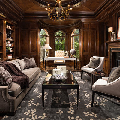 Example of a tuscan freestanding desk dark wood floor home office design in Los Angeles with a standard fireplace