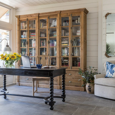 Farmhouse freestanding desk gray floor home office photo in Jacksonville with white walls