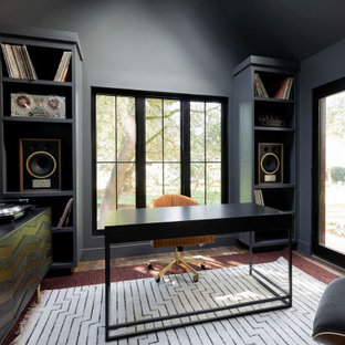 Home office - cottage freestanding desk dark wood floor, brown floor and vaulted ceiling home office idea in San Francisco with gray walls