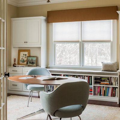Transitional freestanding desk dark wood floor study room photo in Boston with beige walls and no fireplace