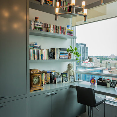 Inspiration for a mid-sized contemporary built-in desk dark wood floor study room remodel in Toronto with white walls