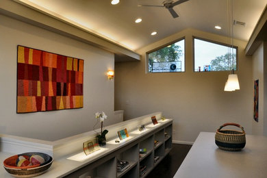 Trendy dark wood floor home office photo in Austin with beige walls
