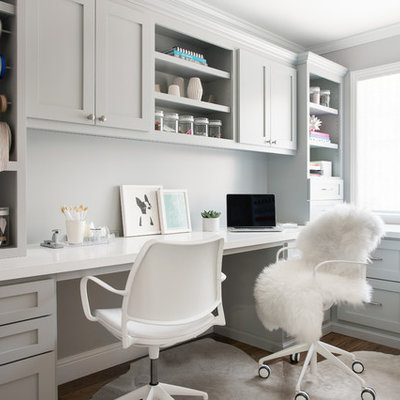 Mid-sized transitional built-in desk medium tone wood floor and brown floor craft room photo in San Francisco with gray walls