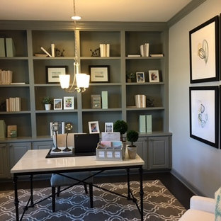 Example of a mid-sized minimalist built-in desk dark wood floor and brown floor study room design in New York with green walls