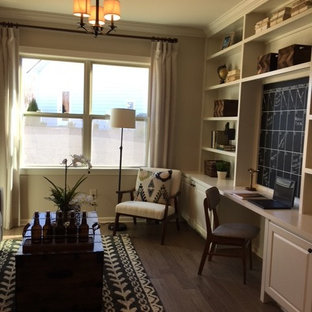 Inspiration for a large modern built-in desk medium tone wood floor and brown floor study room remodel in New York with beige walls