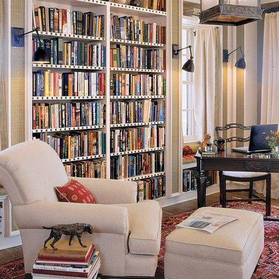Elegant freestanding desk dark wood floor home office photo in Charleston