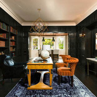 Large tuscan freestanding desk dark wood floor home office library photo in Los Angeles