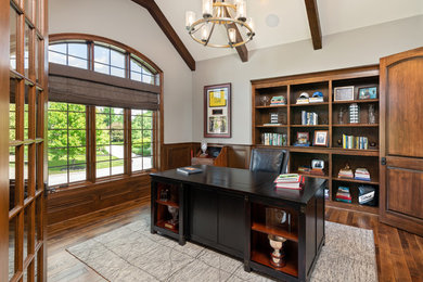 Imagen de despacho clásico de tamaño medio sin chimenea con paredes grises, escritorio independiente y suelo de madera en tonos medios