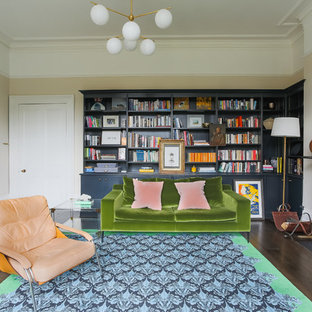 Réalisation d'un bureau tradition avec un mur beige, un sol en bois foncé et un poêle à bois.