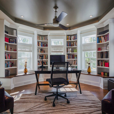 Example of a classic freestanding desk dark wood floor study room design in Chicago with white walls