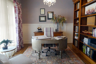 This is an example of a medium sized traditional study in Columbus with purple walls, medium hardwood flooring, no fireplace and a freestanding desk.