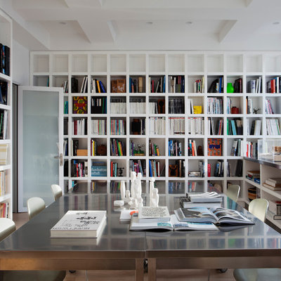 Example of a minimalist freestanding desk home office library design in New York with white walls