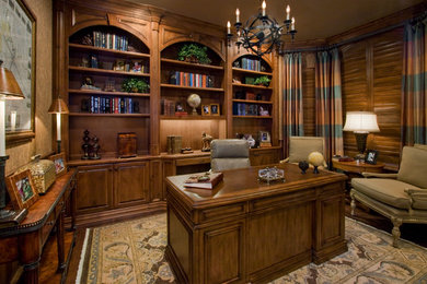 This is an example of a medium sized classic study in Houston with beige walls, medium hardwood flooring and a freestanding desk.