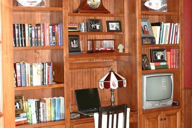 Home office - traditional medium tone wood floor home office idea in Oklahoma City with red walls