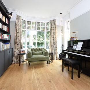 Traditional home office in Manchester with a reading nook, grey walls, light hardwood flooring and beige floors.