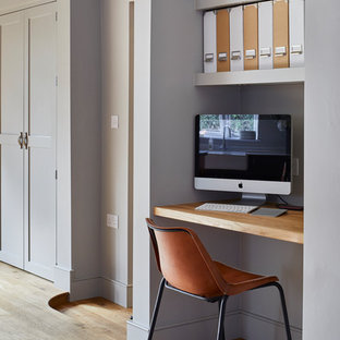 Design ideas for a small traditional study in Dorset with grey walls, light hardwood flooring, no fireplace and a built-in desk.