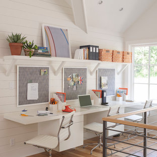 Inspiration for a mid-sized transitional built-in desk light wood floor study room remodel in Boston with white walls