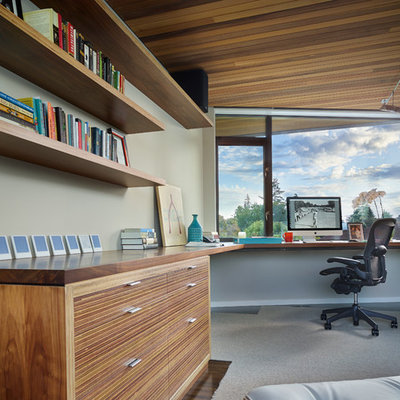 Example of a trendy built-in desk dark wood floor home office design in Seattle with gray walls