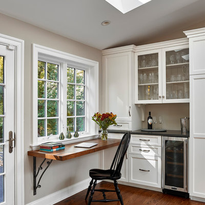 Example of a small classic built-in desk medium tone wood floor study room design in Philadelphia with gray walls