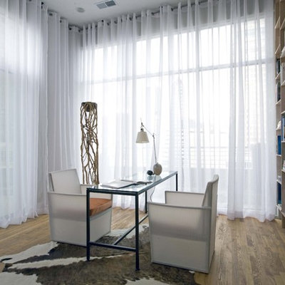 Home office - contemporary freestanding desk medium tone wood floor home office idea in Birmingham