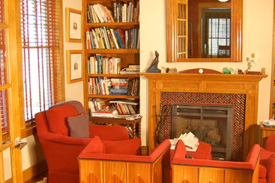 Study room - craftsman freestanding desk medium tone wood floor study room idea in Philadelphia with beige walls, a standard fireplace and a tile fireplace