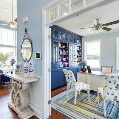 Example of a beach style freestanding desk medium tone wood floor study room design in Philadelphia with blue walls