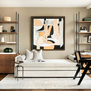 Contemporary study in London with beige walls, medium hardwood flooring, a freestanding desk and brown floors.