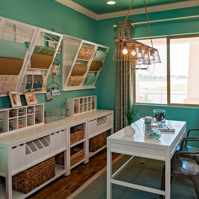 Example of a classic freestanding desk dark wood floor home office design in Phoenix with blue walls