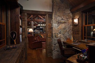 Small rustic study in Boston with medium hardwood flooring and a built-in desk.