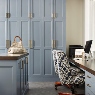 Home office - traditional built-in desk dark wood floor and brown floor home office idea in Minneapolis