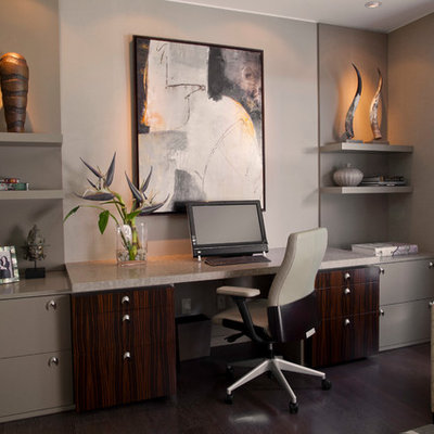 Study room - large contemporary built-in desk dark wood floor study room idea in Miami with gray walls and no fireplace
