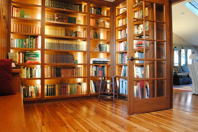 Inspiration for a mid-sized timeless medium tone wood floor and brown floor home office library remodel in Cleveland with no fireplace