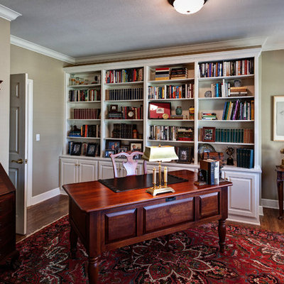 Inspiration for a mid-sized timeless freestanding desk medium tone wood floor study room remodel in Other with beige walls