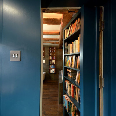 Inspiration for a small farmhouse freestanding desk dark wood floor study room remodel in Kent with blue walls and no fireplace