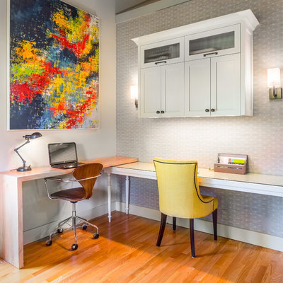 Study room - mid-sized transitional built-in desk medium tone wood floor study room idea in Seattle with gray walls