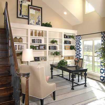 Home office - transitional freestanding desk dark wood floor home office idea in Charlotte with beige walls