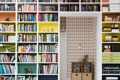 Contemporary study in New York with light hardwood flooring and white walls.