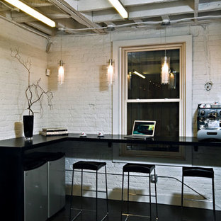 Example of a mid-sized minimalist dark wood floor home office design in DC Metro with white walls