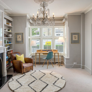 Inspiration for a classic study in London with grey walls, carpet, a standard fireplace, a freestanding desk and beige floors.
