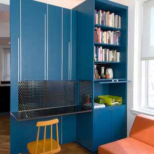 Inspiration for a contemporary built-in desk medium tone wood floor home office remodel in New York with white walls