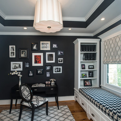 Study room - mid-sized traditional freestanding desk light wood floor study room idea in Houston with black walls and no fireplace
