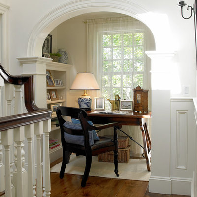 Small elegant freestanding desk dark wood floor study room photo in Boston with white walls
