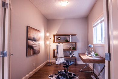 Inspiration for a transitional freestanding desk home office remodel in Edmonton with gray walls