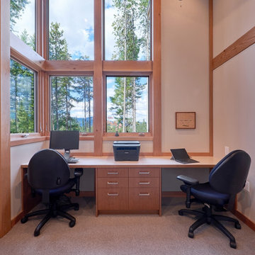 View of the office with built-in desk and vertical grain cherry drawers; window