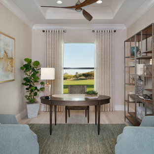 Study room - transitional freestanding desk beige floor study room idea in Miami with beige walls