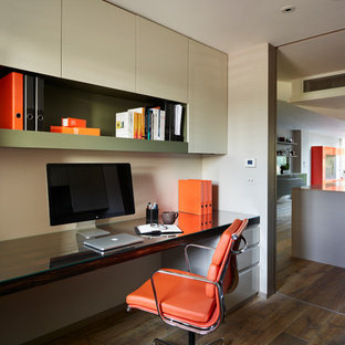 Design ideas for a contemporary study room in London with a built-in desk and dark hardwood floors.
