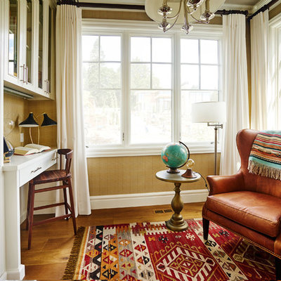 Inspiration for a small timeless built-in desk medium tone wood floor study room remodel in Portland with beige walls