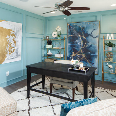 Example of a beach style freestanding desk medium tone wood floor study room design in Charleston with blue walls