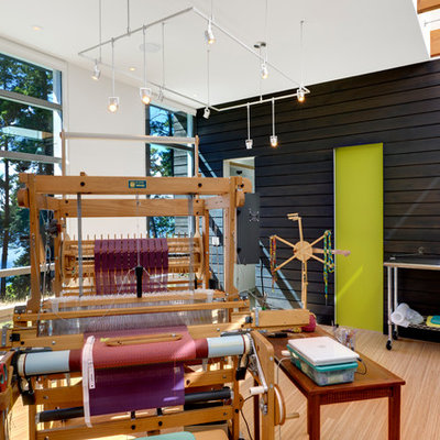 Home studio - contemporary freestanding desk bamboo floor home studio idea in Seattle with white walls