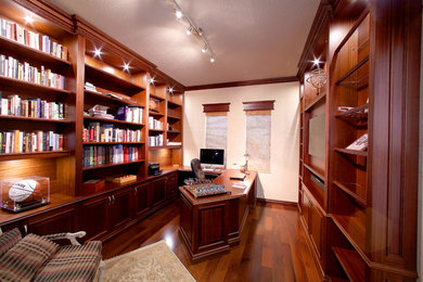 Large elegant built-in desk dark wood floor and brown floor study room photo in Miami with white walls and no fireplace